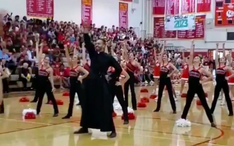 Priest Breaks Out in Epic Dance Routine at School Pep Rally, Dazzling Audience